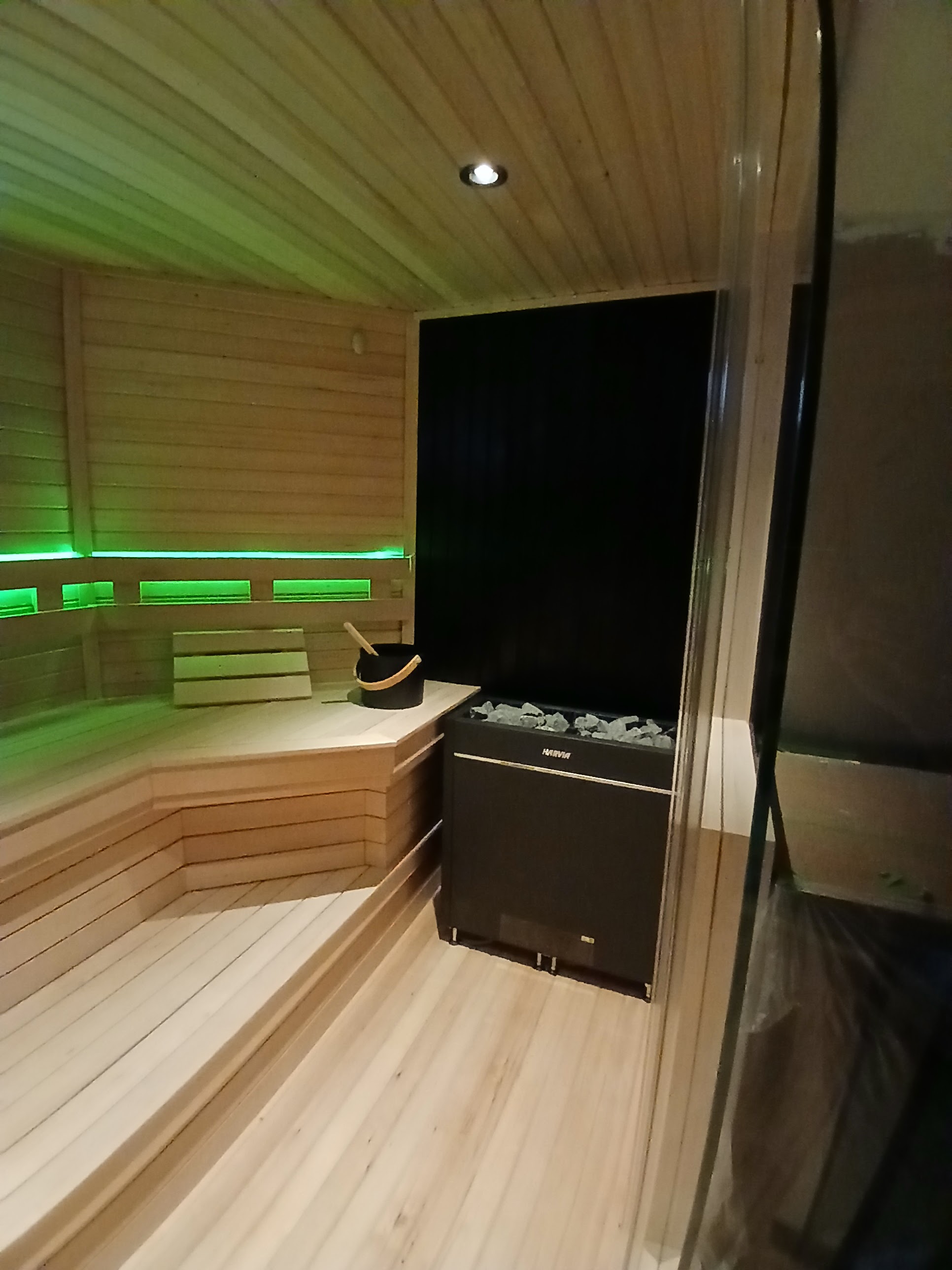 Sauna with Harvia heater and green LED lighting